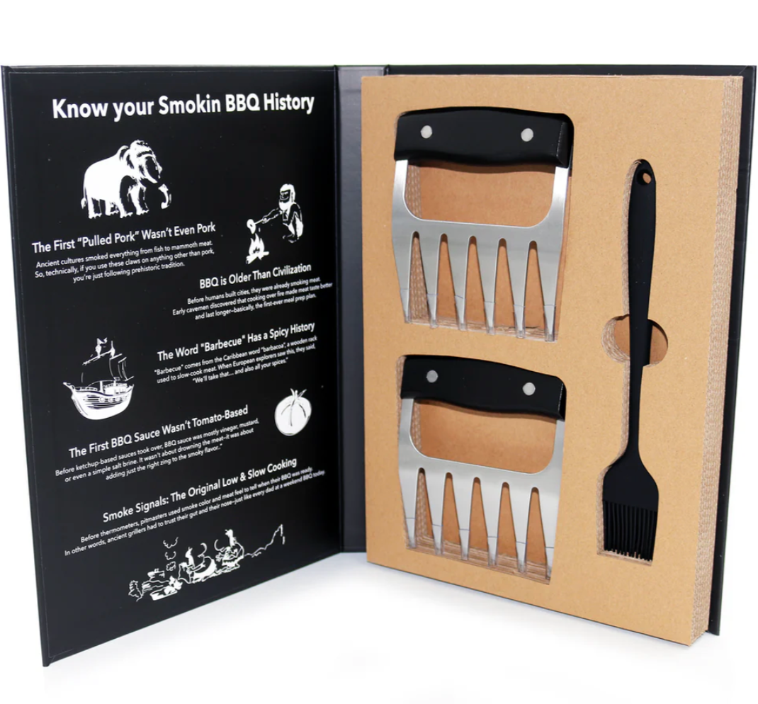 Barbecue utensils set with a history of smoking BBQ text on a black and brown card.