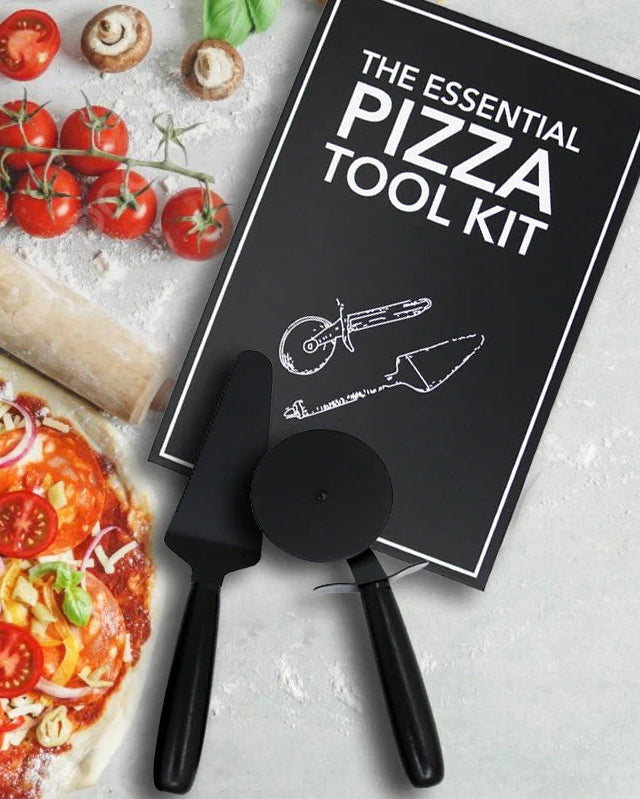 Pizza tool kit with pizza and ingredients on a textured surface